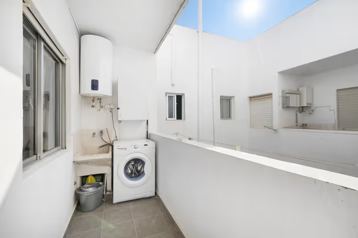 Kitchen prep area with sink and access to utility