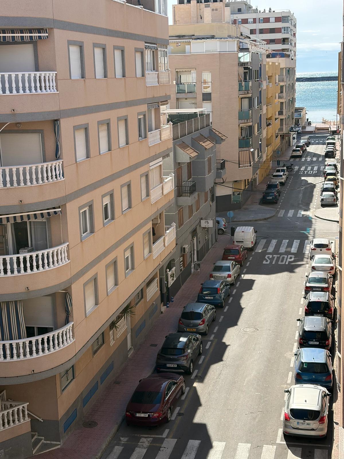 View from the apartment with the Mediterranean visible at the end of the street